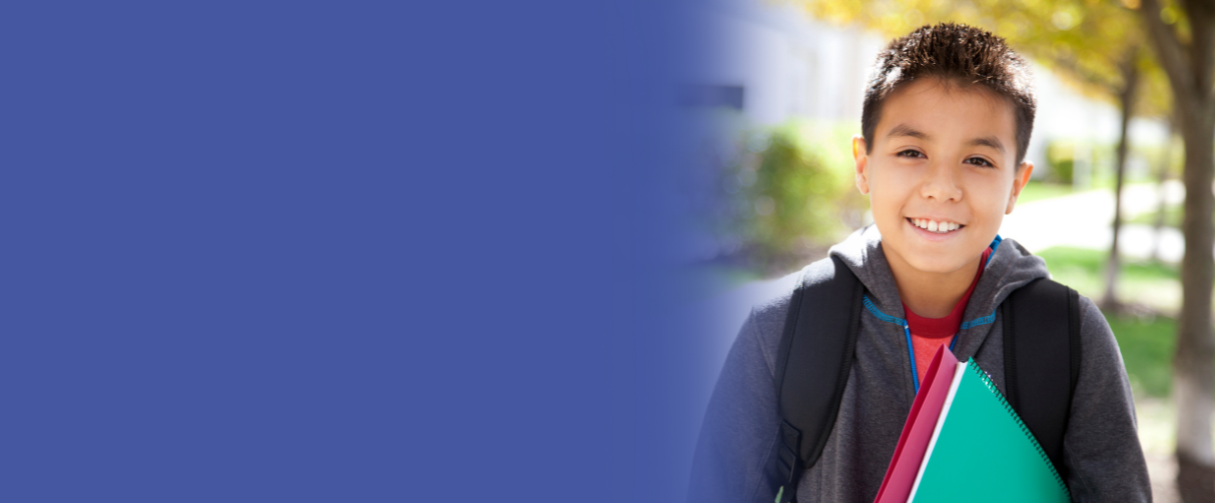A Latino boy smiles at the camera