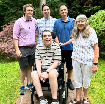 Chris and his family smile at the camera