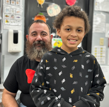 Mr. Puckett smiles with a student