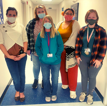 Five Harrisonburg teachers post together in a hallway