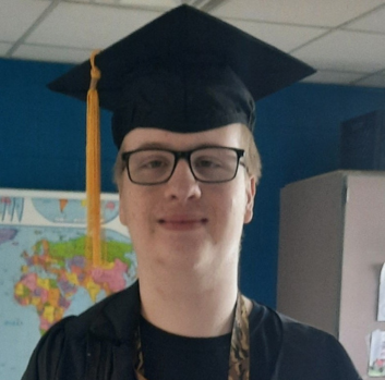 Hunter smiles in his graduation cap