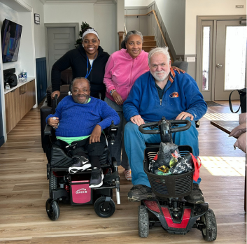 Leteane smiles at the camera with roommates from his Group Home