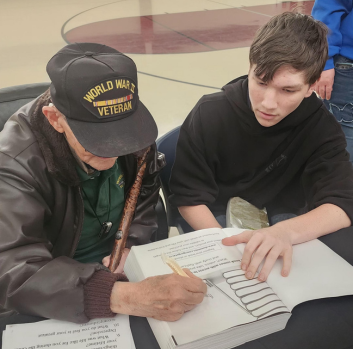 Mr. Jennings signs Jacob's book