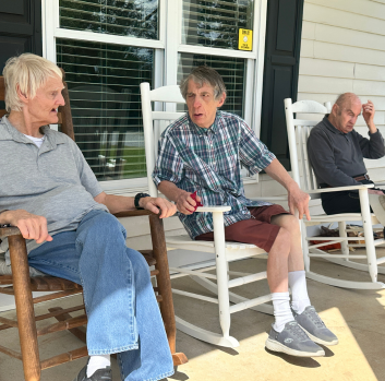 Ronnie, Ed, and Charles sit on their new front porch