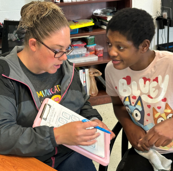 Stephanie works with a student