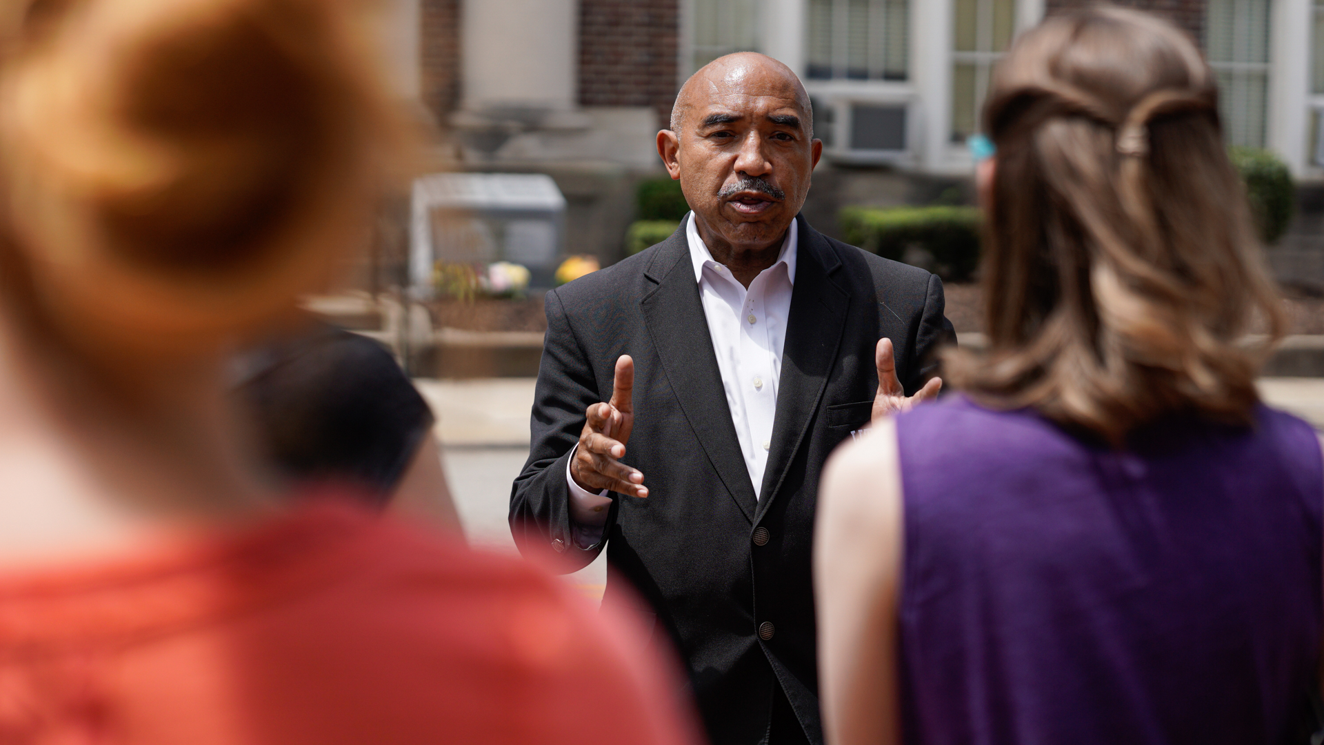 Gary Flowers speaks as enCircle staff look on