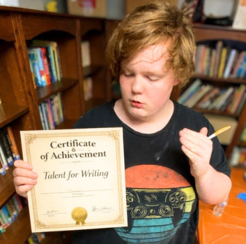 Aiden shows his certificate