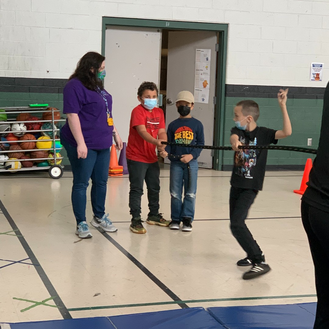 Students play tug-of-war in the gym