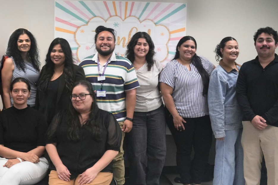 Immigration and foster care staff smile for the camera