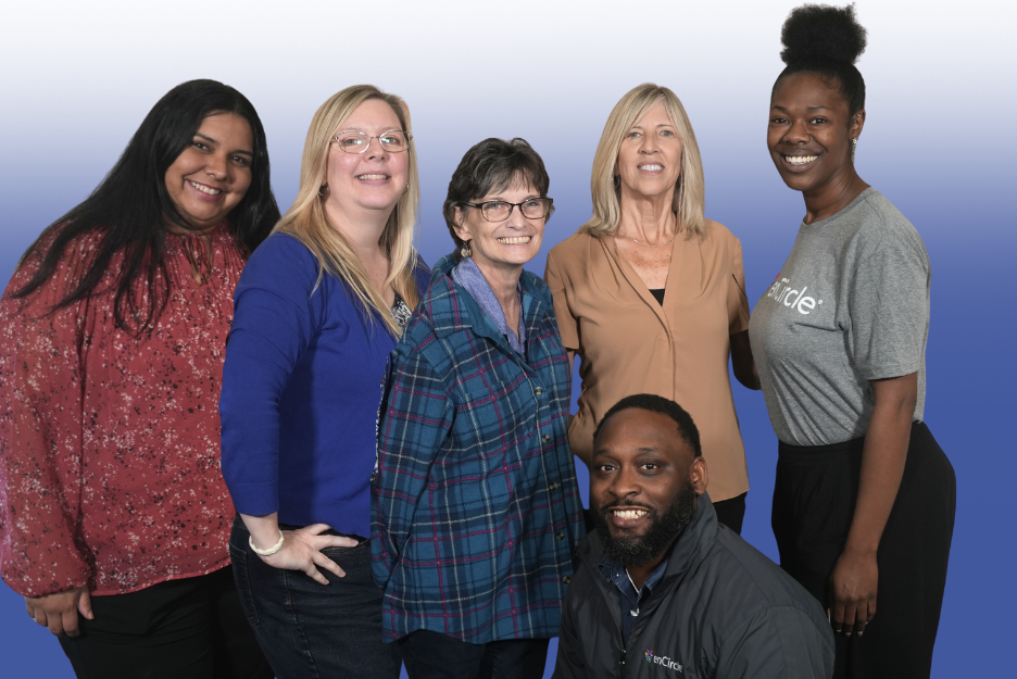 Foster care and Immigration staff smile at the camera