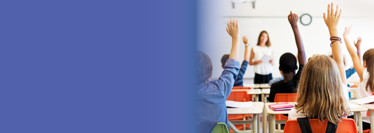 Students in a classroom raise their hands