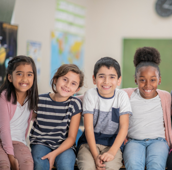 Children of different races smile at the camera